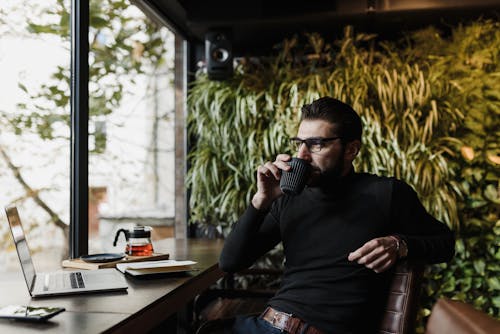 A Man Sitting Drinking Coffee