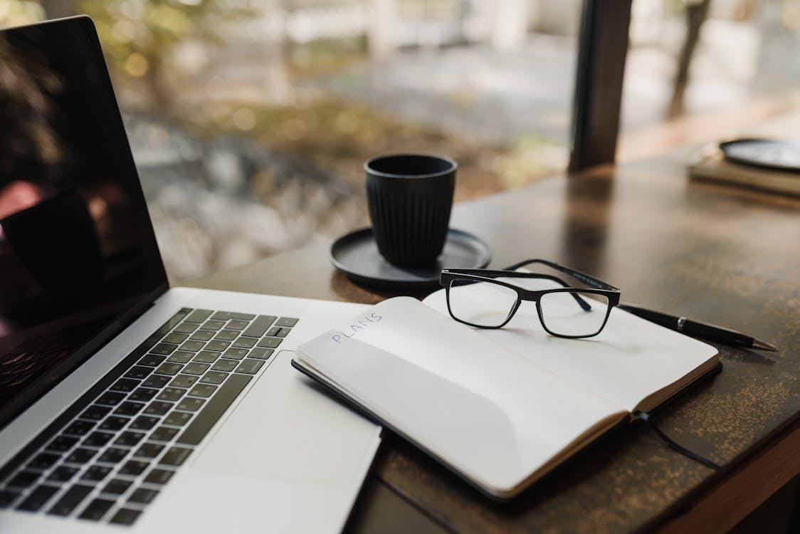 Black Framed Eyeglasses on Notepad