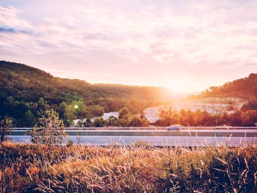 Vehicle on Road during Sunset