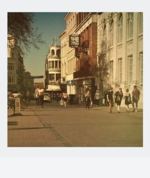 Free Strolling through a bustling city street with historic architecture and vibrant activity. Stock Photo