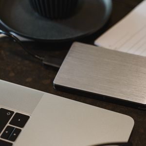 An external hard drive connected to a laptop on a desk — Arina Krasnikova on Pexels