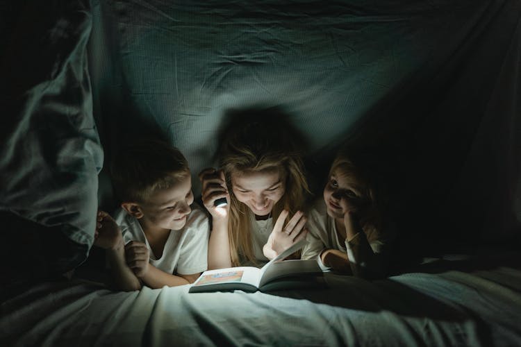 Mother And Kids Reading A Book