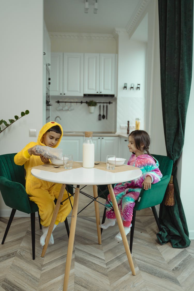 Brother And Sister Eating Breakfast Together