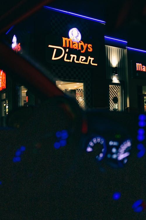 Free Through car windscreen of illuminated signboard of modern diner located in city at dark night Stock Photo