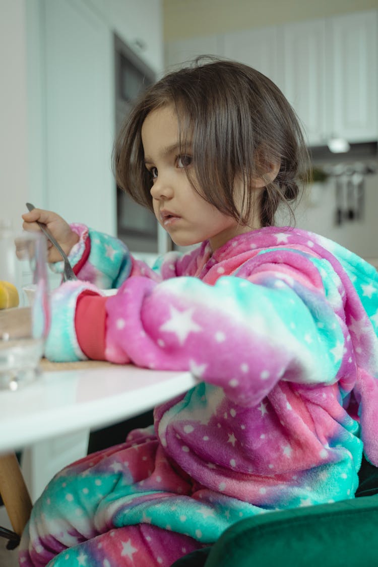 A Girl Wearing A Costume While Eating Cereal