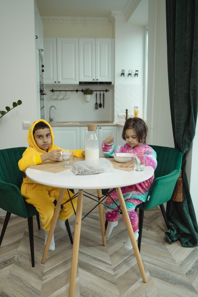 A Boy And Girl Eating A Breakfast Together 