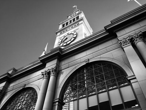 Free Black and white view of the historic San Francisco Ferry Building with iconic clock tower. Stock Photo