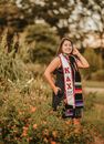 Happy ethnic woman near bush