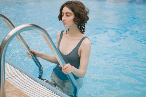 Free A Woman in the Swimming Pool Grab Bar Stock Photo