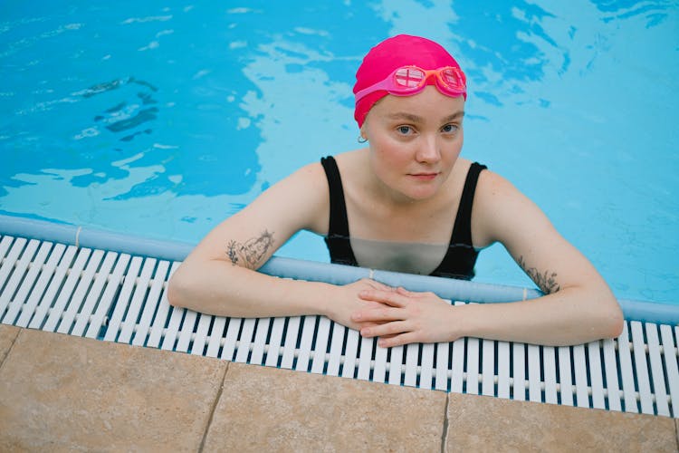 Woman In Swimming Cap Standing In The Pool 