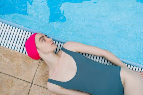 Overhead View of Woman Lying on Edge of Swimming Pool