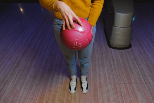 Woman Holding a Pink Bowling Ball 
