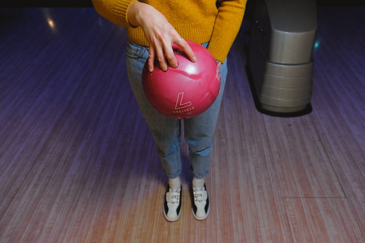 Woman Holding A Pink Bowling Ball 