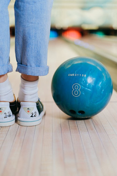 Close Up of Bowling Bowl and Woman Legs