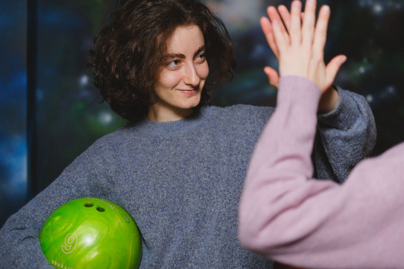 Friends high five after a strike