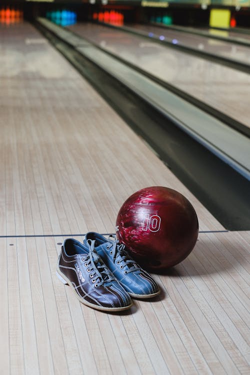 Bowling Shoes and Ball on Floor of Bowling Alley