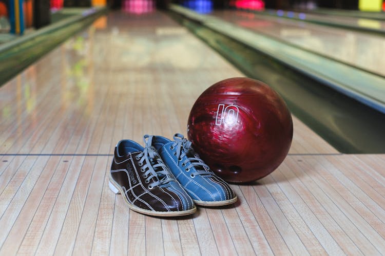 Bowling Ball And Shoes On Alley