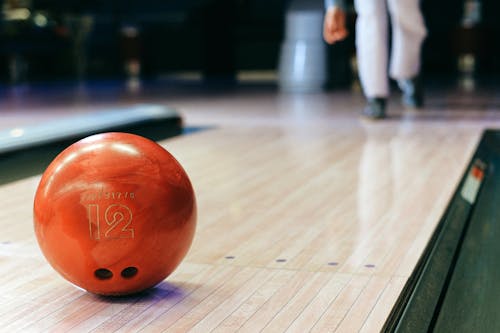 Close-Up Shot of a Brown Bowling Ball on the Bowling Alley