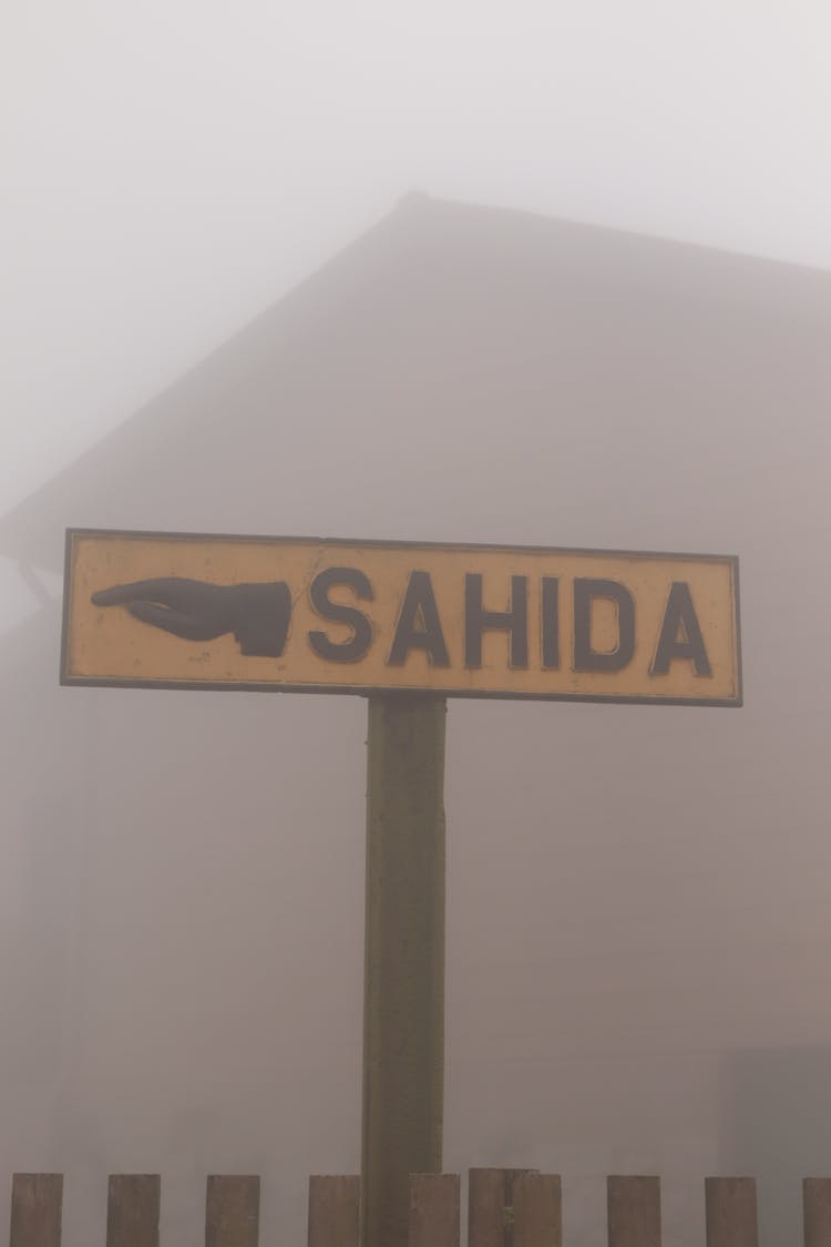 Road Sign Showing Direction In A Dense Fog