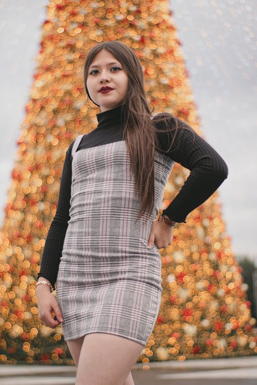 Woman in Checkered Short Dress Posing with Hand on Waist