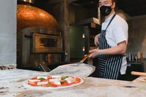 Chef Making Pizza in Restaurant