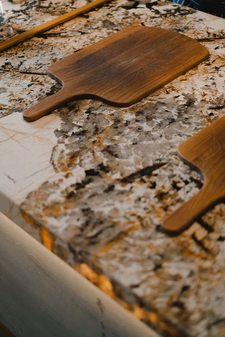 Wooden Paddle Tray On A Marble Countertop