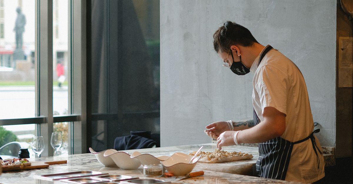 Cook Working in the Kitchen and Wearing a Face Mask · Free Stock Photo
