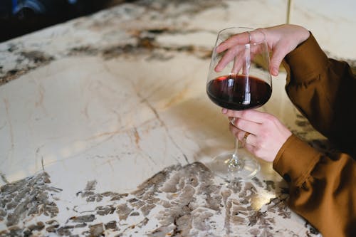 A Person Holding a Glass of Red Wine 