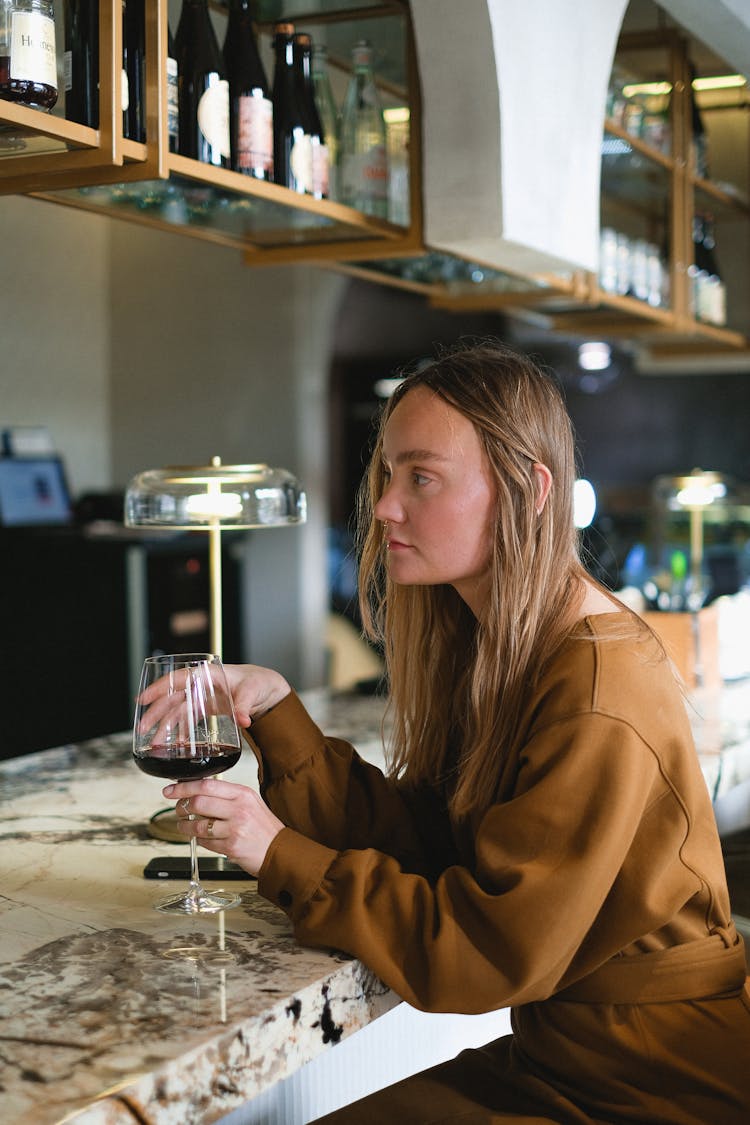 Woman Relaxing In Restaurant With Wine