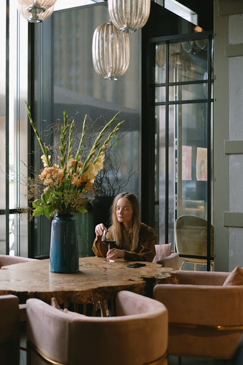 A Woman Having a Glass of Red Wine
