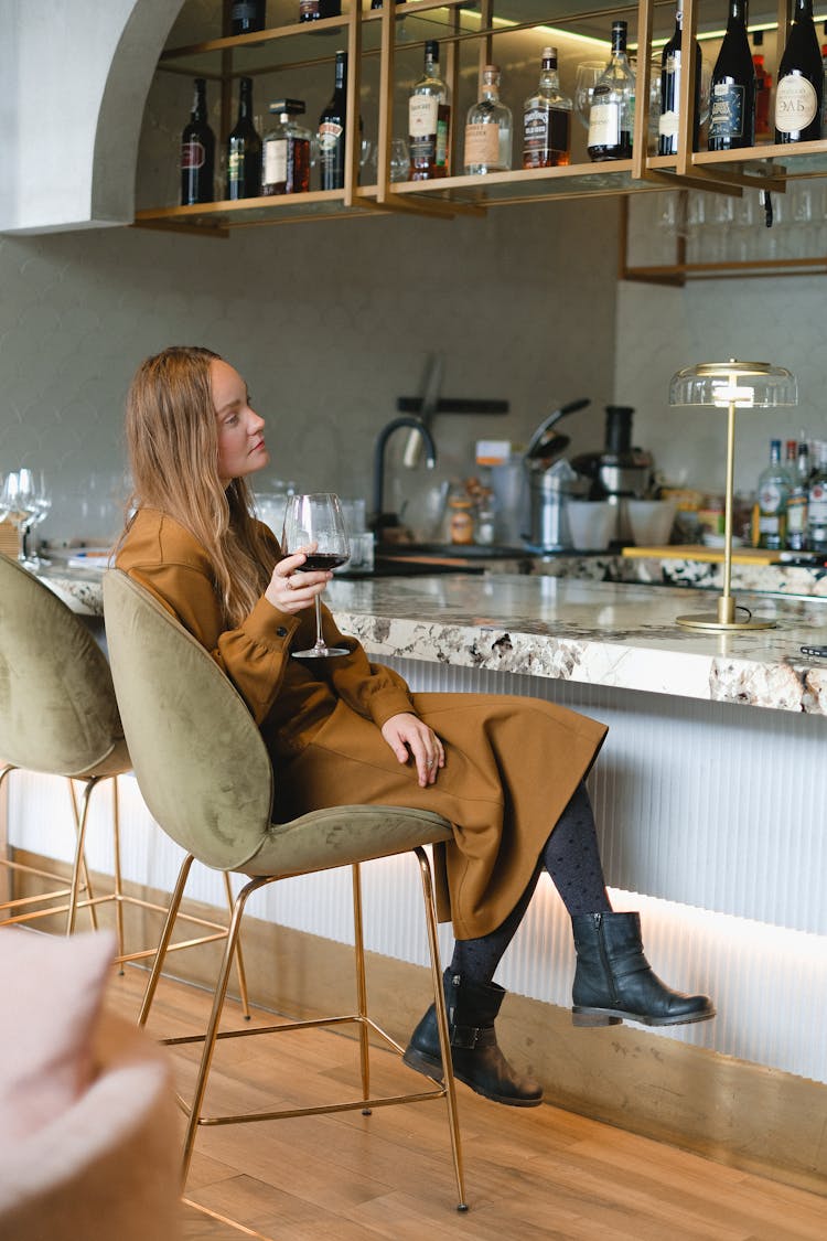 Woman Drinking Red Wine At Bar
