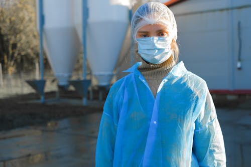 A Woman Wearing a Hair Net and a Face Mask