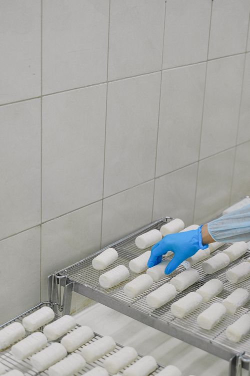Person with Blue Latex Gloves Getting a Roll of Gauze From a Rack ...
