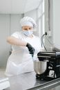 Person in White Chef Uniform Holding Blue Handled Knife