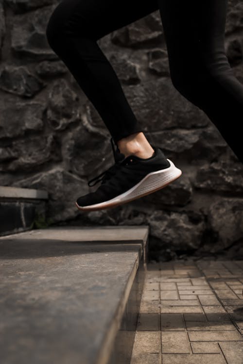 Free Unrecognizable person running on stairs outside Stock Photo