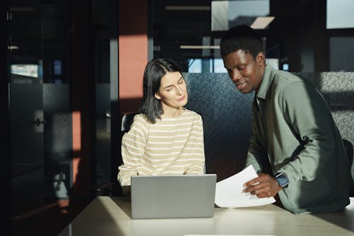 Free A Man and Woman Having a Meeting in the Office Stock Photo