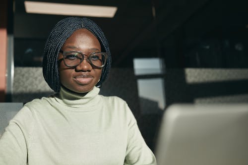 Free Woman in White Turtleneck Long Sleeve Shirt Wearing Black Framed Eyeglasses Stock Photo