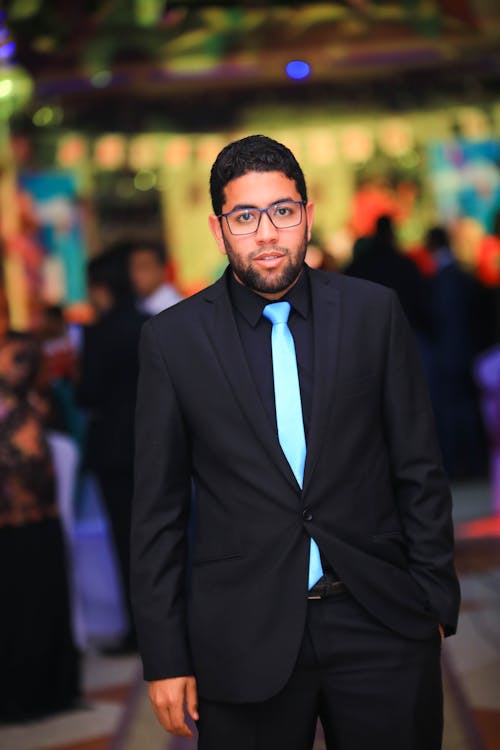 Man in Black Suit Jacket With Blue Necktie