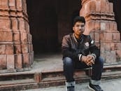 Man in Black Jacket Sitting on the Floor
