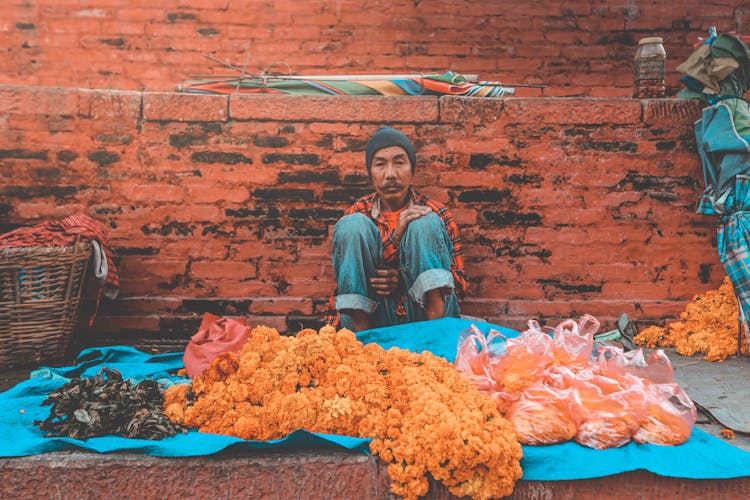 Asian Seller With Assorted Herbs In Local Market