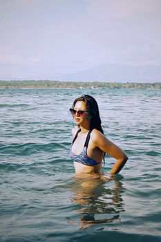 Woman enjoying a sunny day in the sea, Central Luzon, Philippines.