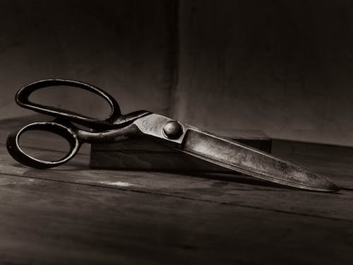Free Silver Scissors on Brown Wooden Table Stock Photo