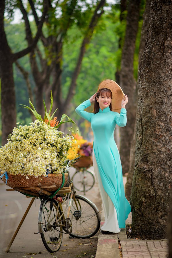Woman Standing Beside a Big Bouquet of White Flowers