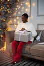 Man in White Dress Shirt and Red Pants Sitting on Gray Couch