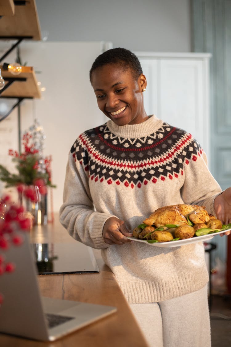 Woman Carrying A Tray Of Roasted Chicken