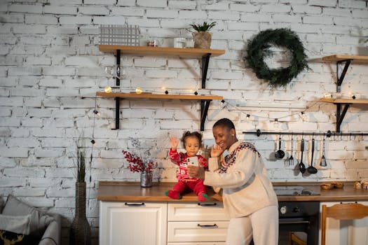 A joyful mother and child video calling in a festive kitchen environment.