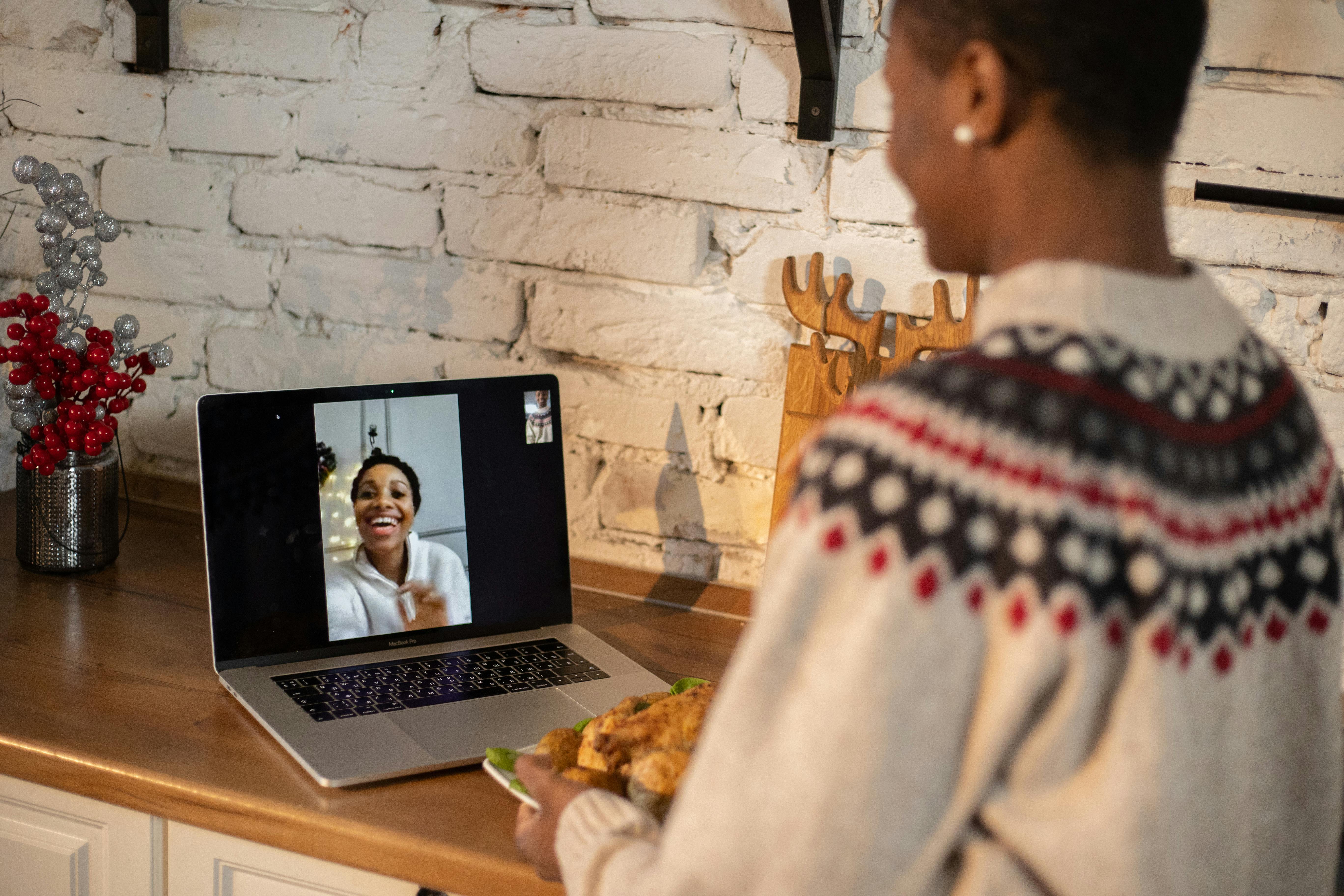 woman standing in front of a laptop