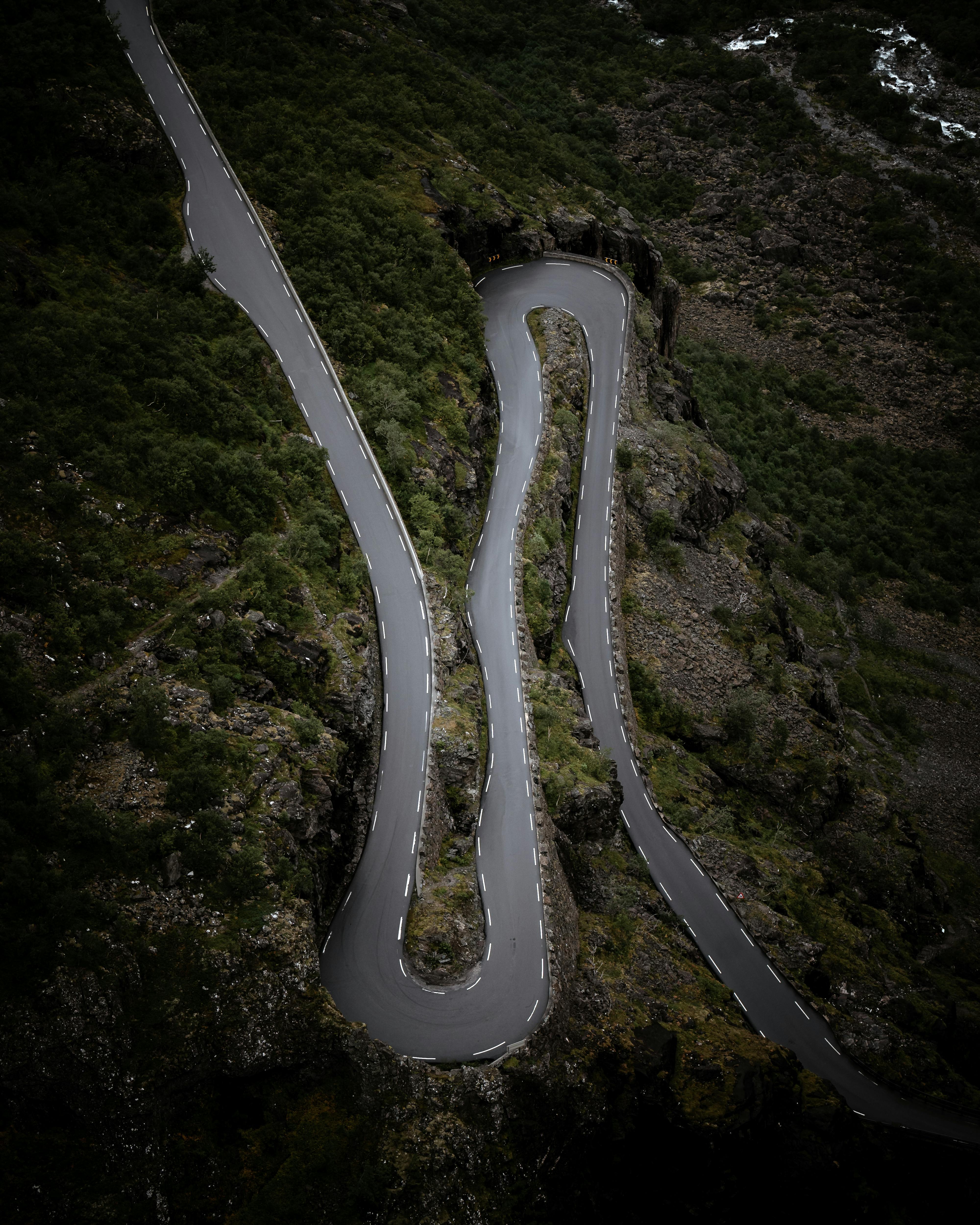 Stunning aerial shot of a winding road through lush mountains in Norway.