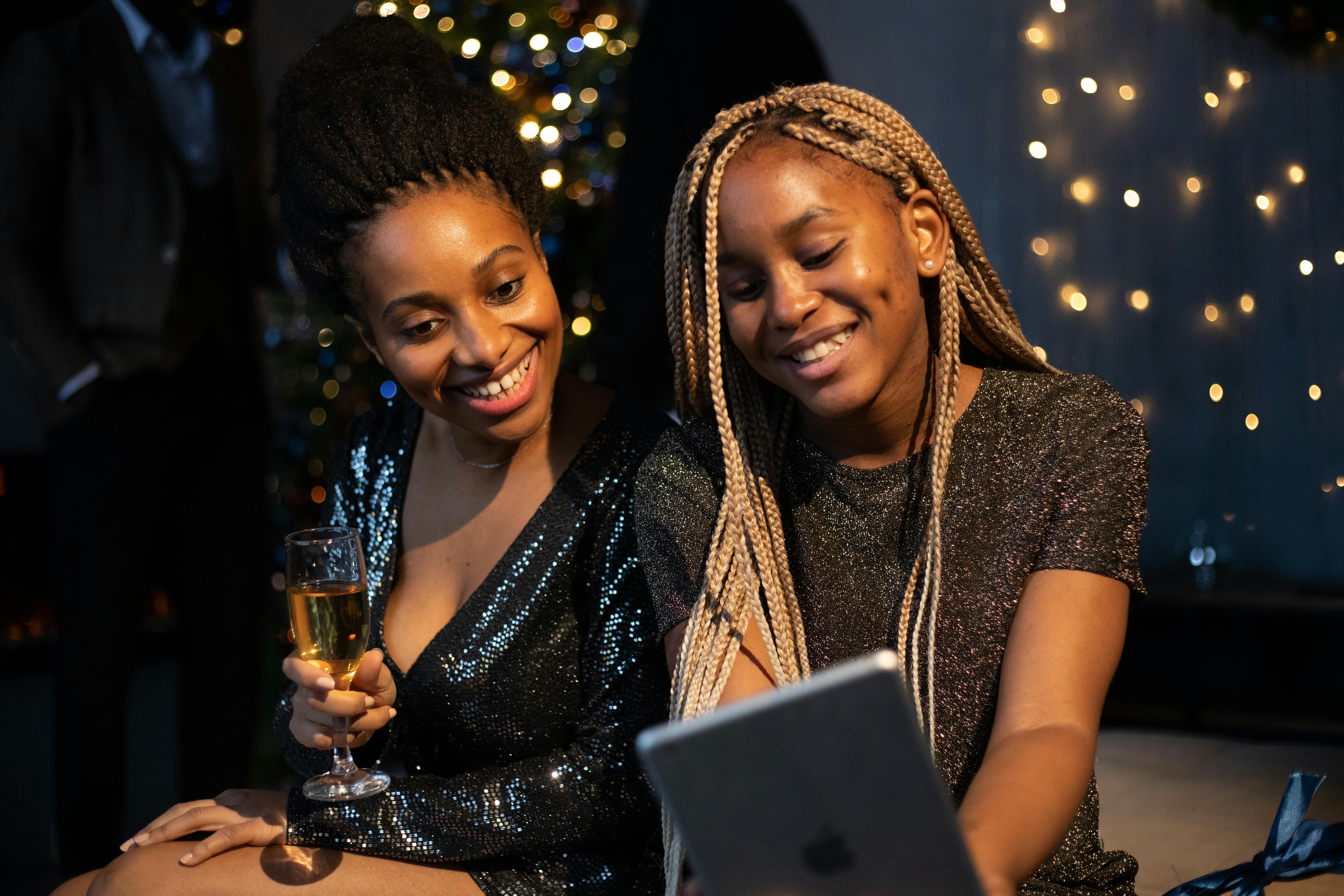 Two Black women at event with champagne