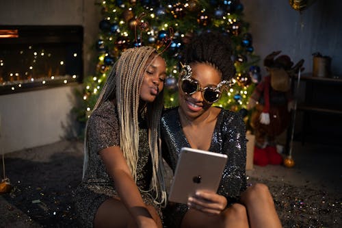 Free Woman Holding An Ipad Beside Another Woman Stock Photo
